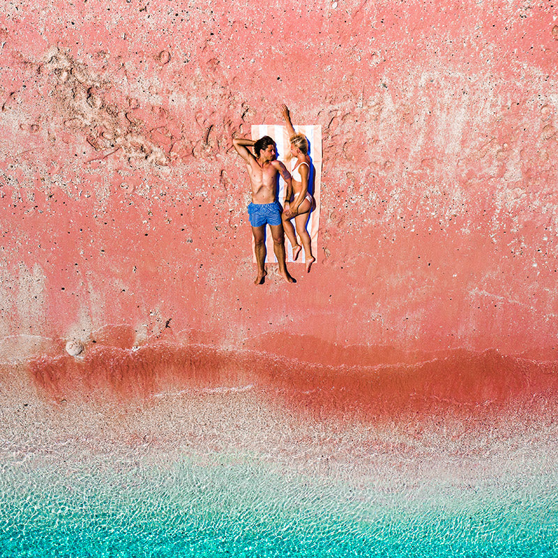 couple lying  on the sand free beach towel at the red beach